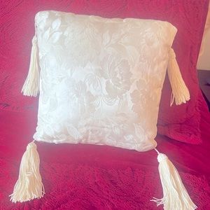 Ivory satin pillow. Used once to carry wedding rings.
